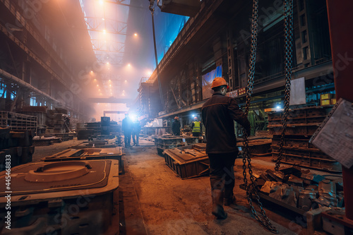 Metallurgical plant. Industrial steel production. Interior of metallurgical workshop inside with workers. Steel mill factory. Heavy industry foundry.