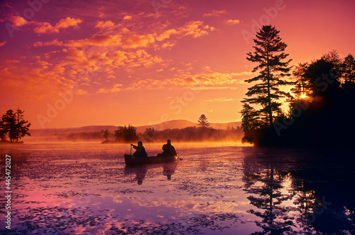 Bob Theodore and Natasha Malcolm (R) canoeing in McDaniel's Marsh in Springfield, New Hampshire USA photo