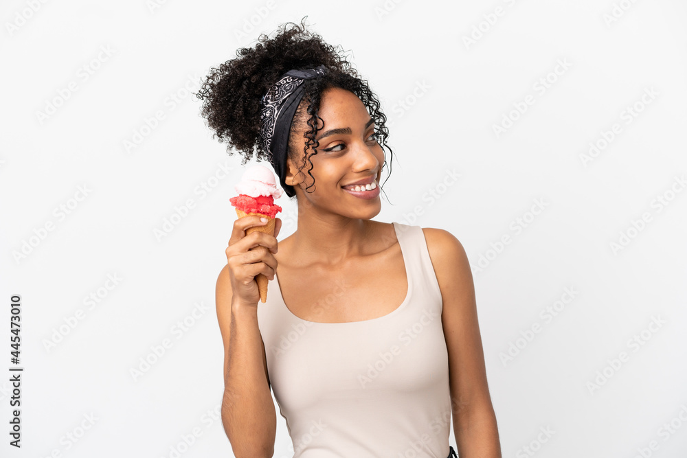 Young african american woman with a cornet ice cream isolated on white background looking side Young african american woman with a cornet ice cream isolated on white background looking side