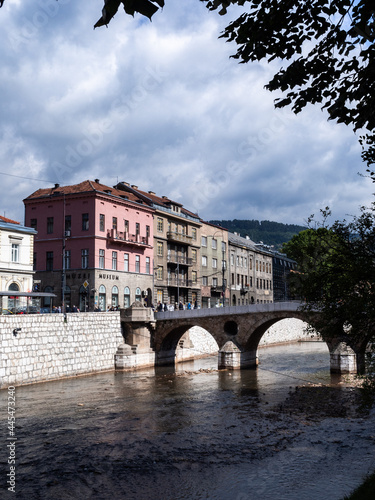 Peek to the Latin Bridge, through some trees, over the Miljacka river. Sarajevo, Bosnia and Herzegovina. photo