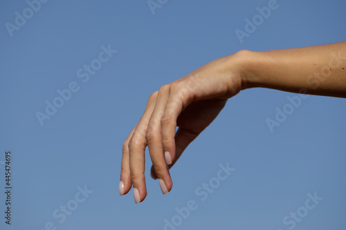 Sensual woman hand. hands in the sky. Idea. Background.  © Erika