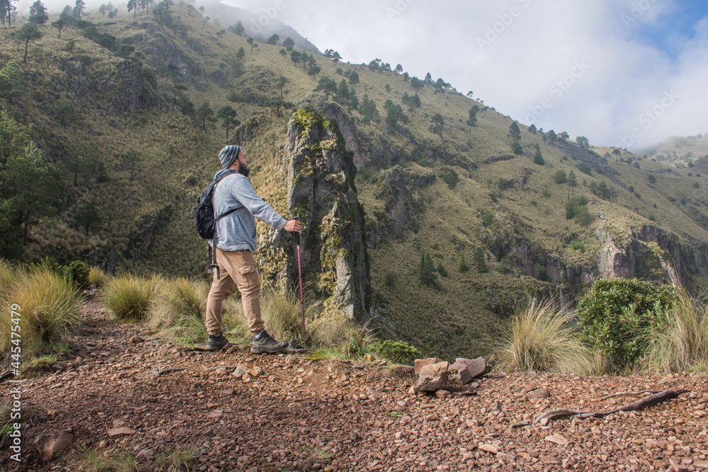 Man watching mountainous landscape on footpath Man watching mountainous landscape on footpath