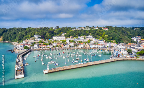 Aerial drone image of St Aubn's Harbour and Village at high tide in the sunshine. Jersey Channel Islands