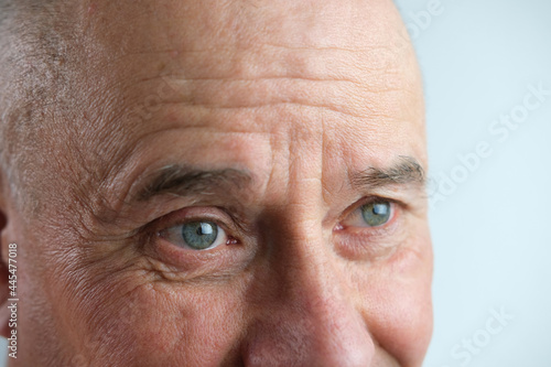 close-up of face old man, senior with deep wrinkles, cheerful gray eyes laugh, concept human emotion, meet old age with dignity