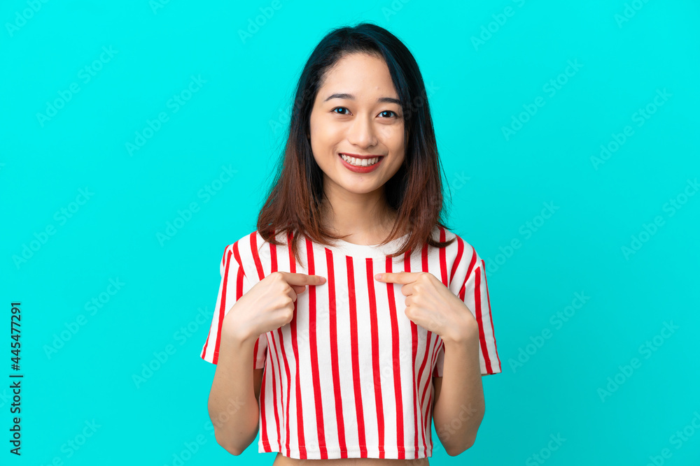 Young Vietnamese woman isolated on blue background with surprise facial expression Young Vietnamese woman isolated on blue background with surprise facial expression