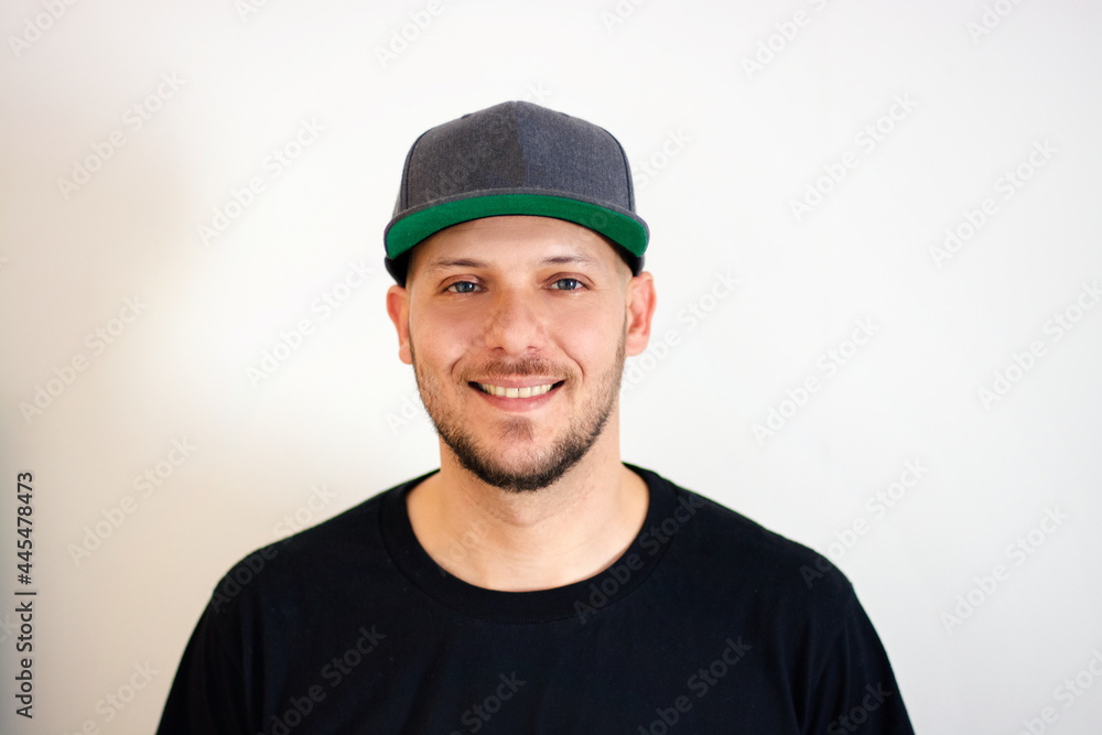 white man smiling in cap and black t-shirt on white background white man smiling in cap and black t-shirt on white background