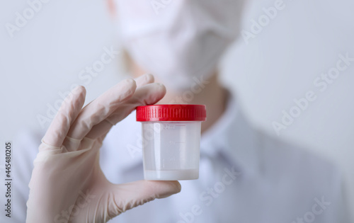 Wallpaper Mural The doctor looks at the pills in a plastic cup in his hand. Medacine, Pills, medicine, vitamins concept. Close up, selective focus Torontodigital.ca