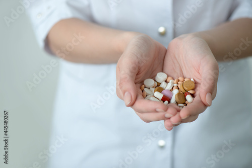 Female hands of doctor or nurse with collection of pills and drags. The concept of medicine, pharmacy and health. Close up, selective focus