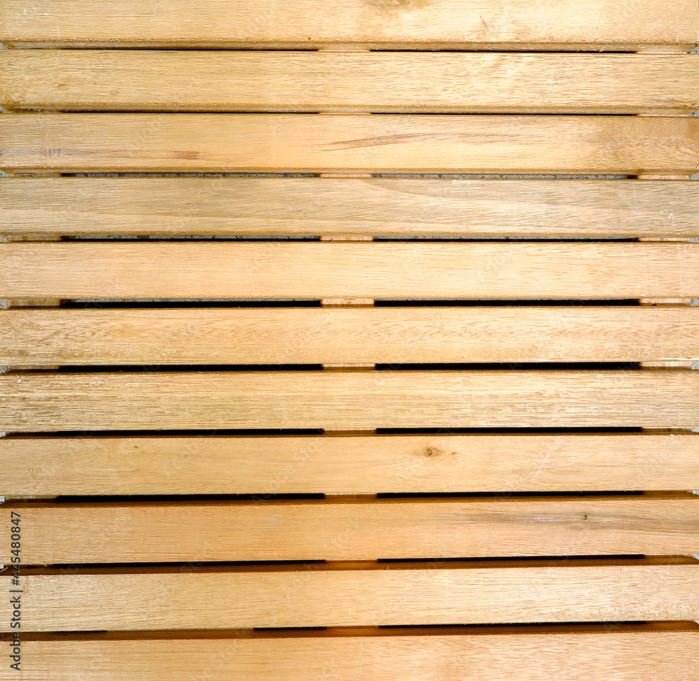 Fototapeta premium texture of yellowish wooden slats aligned horizontally with cracks in full frame