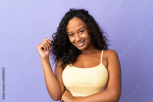 Teenager cuban girl isolated on purple background laughing