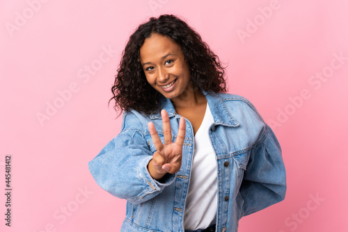 Teenager cuban girl isolated on pink background happy and counting three with fingers