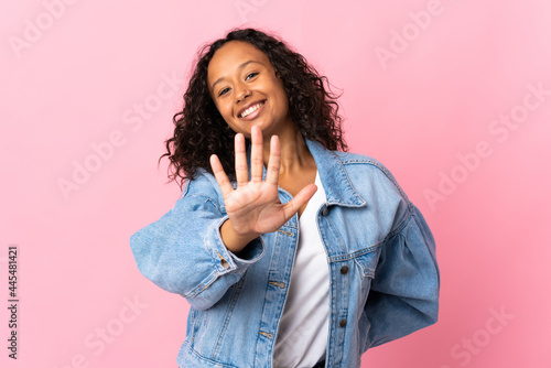 Teenager cuban girl isolated on pink background counting five with fingers