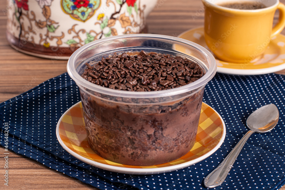 cake in brigadeiro pot on wooden background cake in brigadeiro pot on wooden background