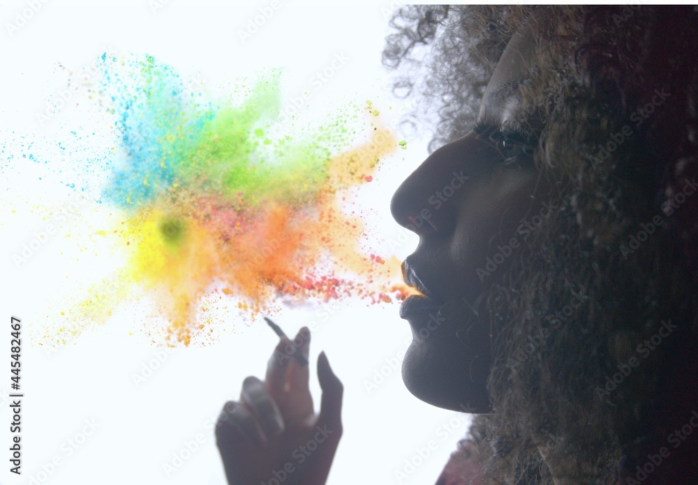 Fototapeta premium young curly hair woman smoking at night drug reference