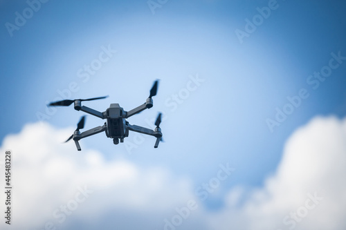 Selective blur on a Small unregistered consumer drone flying. These kind of small drones don't need license to be operated, as they are light and meant for beginners, amateurs and enthusiasts. ..