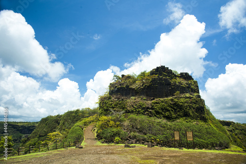 Fort Rangana surrounded by the Western Ghats under a blue cloudy sky in India photo