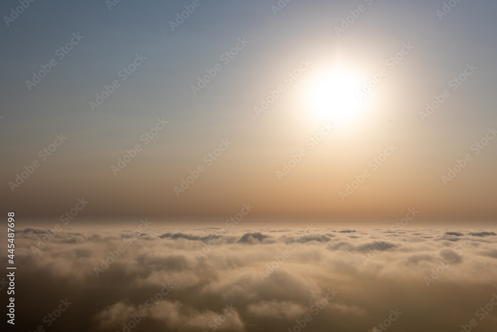 Aerial sunset view over the cloud facing the sun. Scenic view above the clouds Aerial sunset view over the cloud facing the sun. Scenic view above the clouds