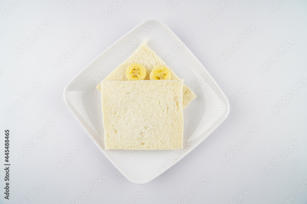 Delicious Ripe yellow bananas fruits with white bread isolated on white background, Banana toping on white bread