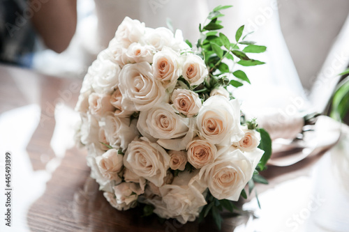 classic wedding bouquet of the bride in bright colors white roses and greenery