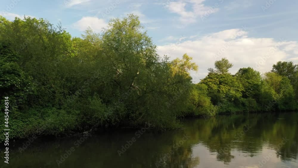Fly above water surface, showing trees and shrubs on banks Fly above water surface, showing trees and shrubs on banks