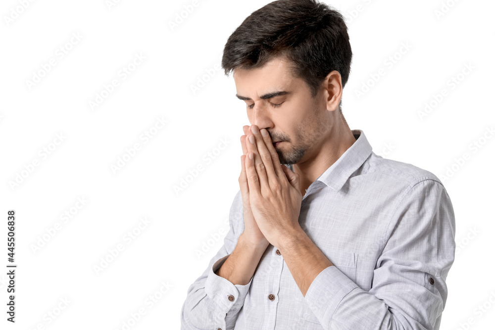 Religious young man praying on white background Religious young man praying on white background