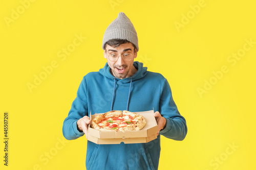 Surprised young man with ta...