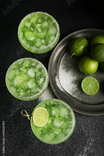 Glasses of tasty daiquiri cocktail on dark background © Pixel-Shot