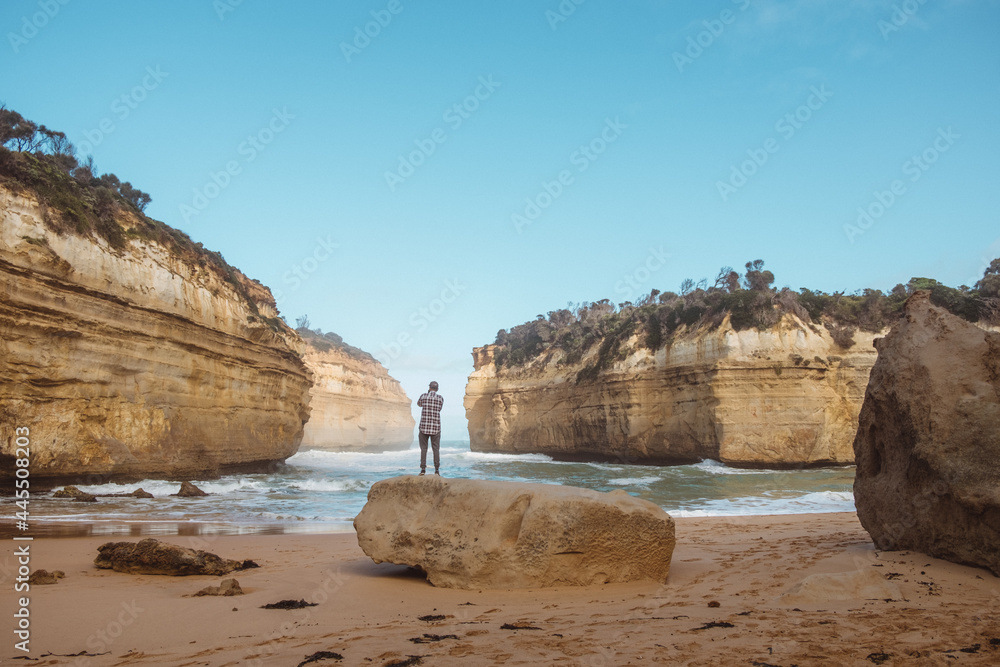 Great ocean road in australia, Loch ard gorge limestone rock formations bay, person taking photo