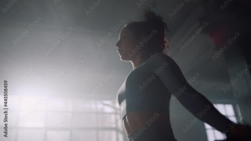 Active girl exercising on jump rope. Energetic woman jumping on skipping rope Active girl exercising on jump rope. Energetic woman jumping on skipping rope