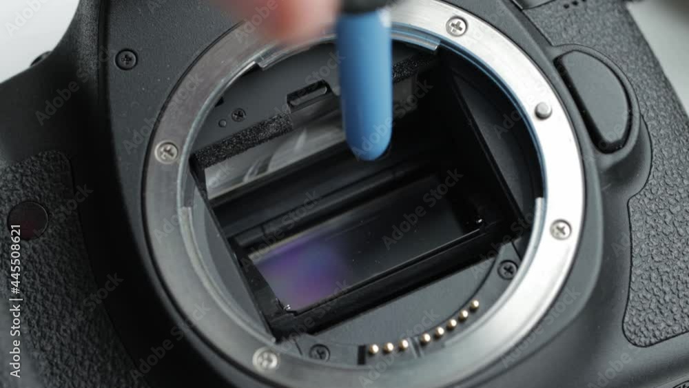 Cleaning the matrix of a modern camera from dust and dirt using special equipment. Maintenance of electronic equipment, macro Cleaning the matrix of a modern camera from dust and dirt using special equipment. Maintenance of electronic equipment, macro