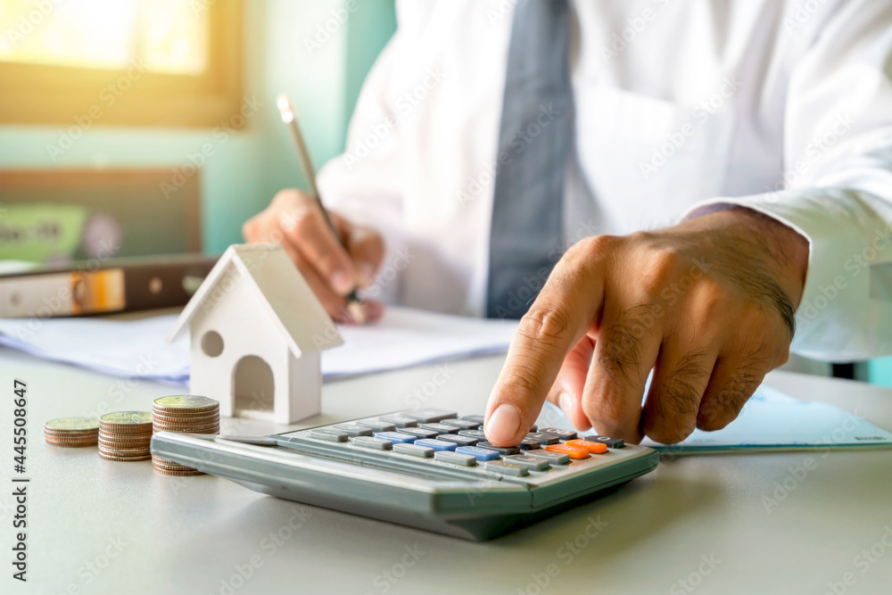 Close-up of women using calculators and note-taking, accounting reports, cost-calculation ideas, and saving money. Close-up of women using calculators and note-taking, accounting reports, cost-calculation ideas, and saving money.