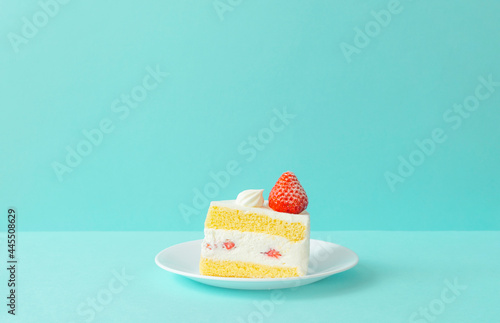Behang strawberry sponge cake on light blue background