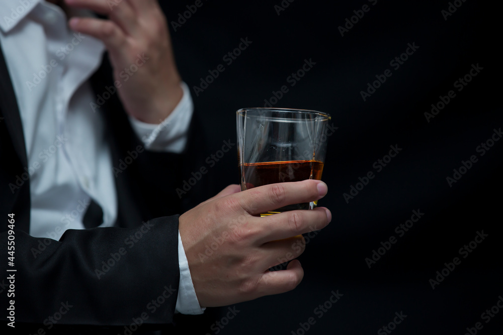 Closeup businessmen holding a glass of whiskey Closeup businessmen holding a glass of whiskey