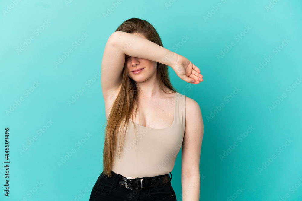 Teenager girl over isolated blue background covering eyes by hands Teenager girl over isolated blue background covering eyes by hands