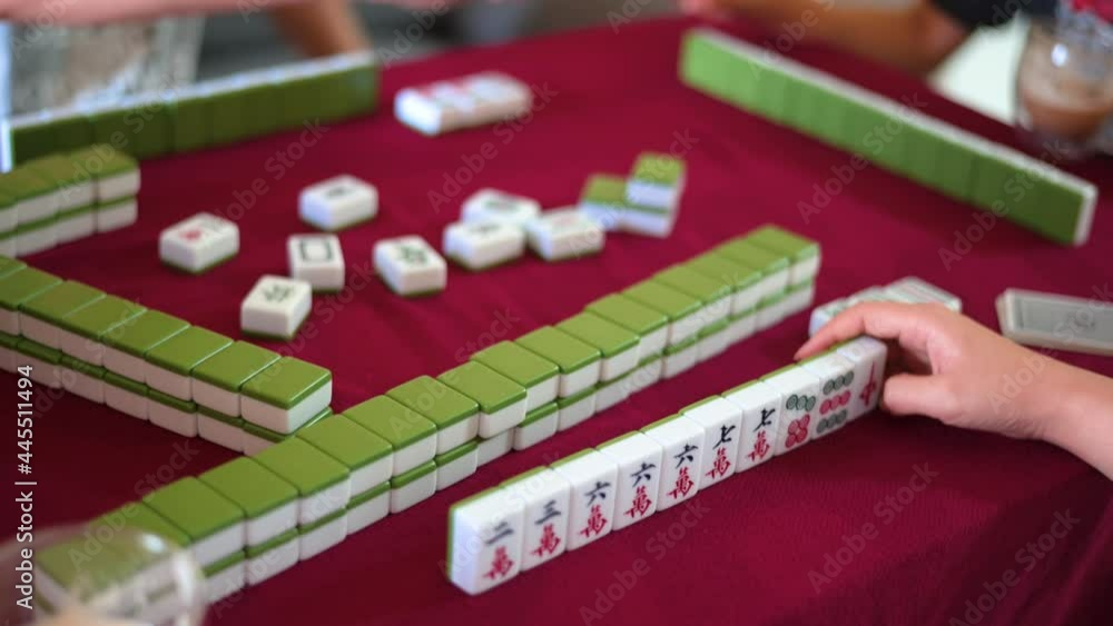 People playing mahjong traditional Chinese board game People playing mahjong traditional Chinese board game