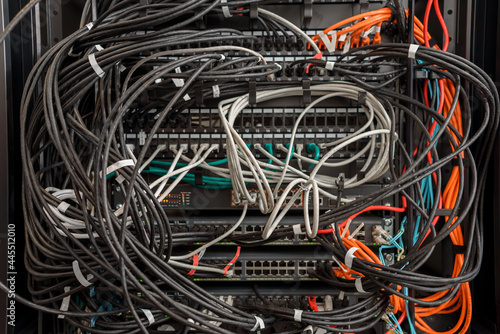 Fotografia Working servers, switches or routers in data center with a lot of cables in a me