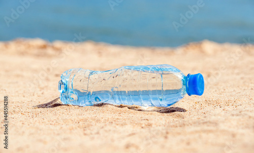 A bottle of drinking water on the sea beach