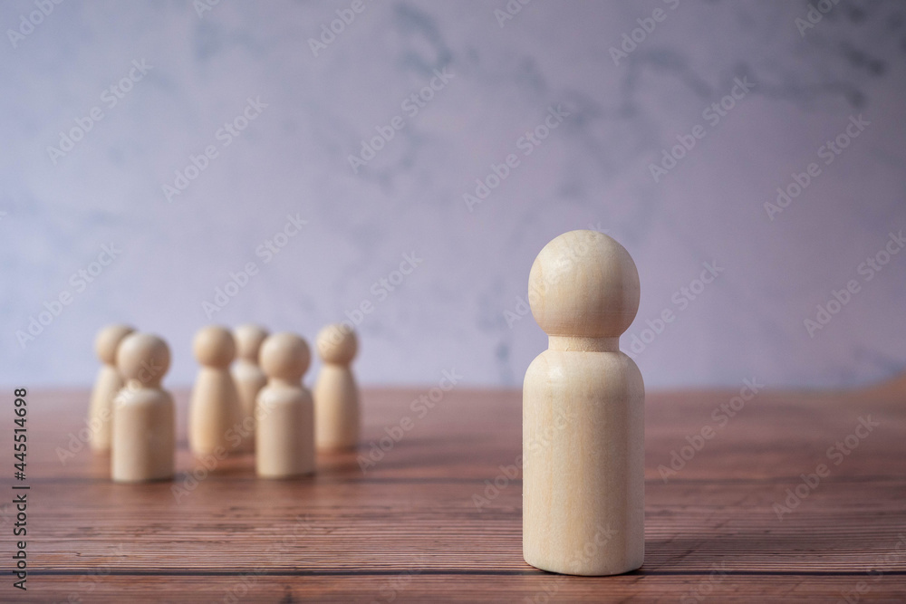Wooden figures standing out from crowd.Depicts the ability of individual to influence and lead followers of other members.Success or talent and think different business creative concept.Unique Person