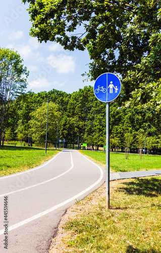 Bicycle and pedestrian paths in the park with a sign