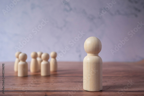 Wooden figures standing out from crowd.Depicts the ability of individual to influence and lead followers of other members.Success or talent and think different business creative concept.Unique Person