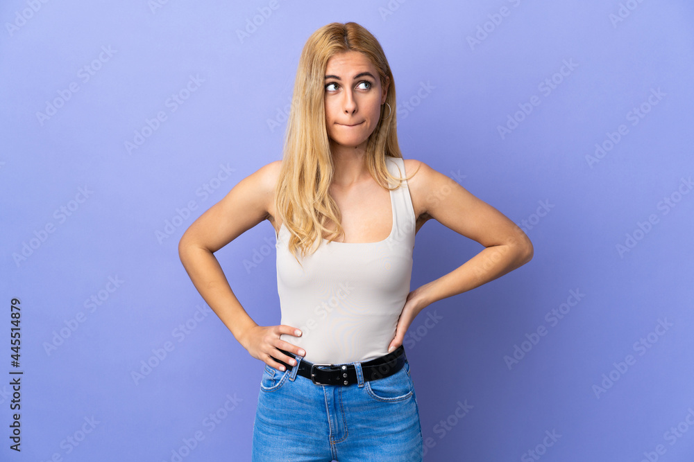 Young Uruguayan blonde woman over isolated background having doubts while looking up Young Uruguayan blonde woman over isolated background having doubts while looking up