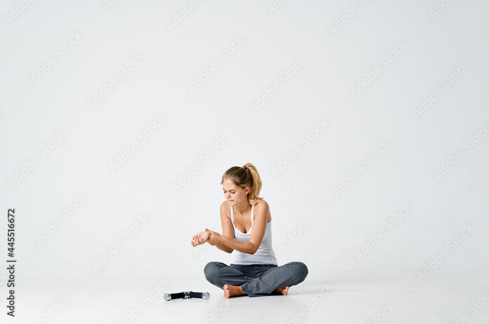 athletic woman sitting on floors dumbbells isolated background motivation fitness
