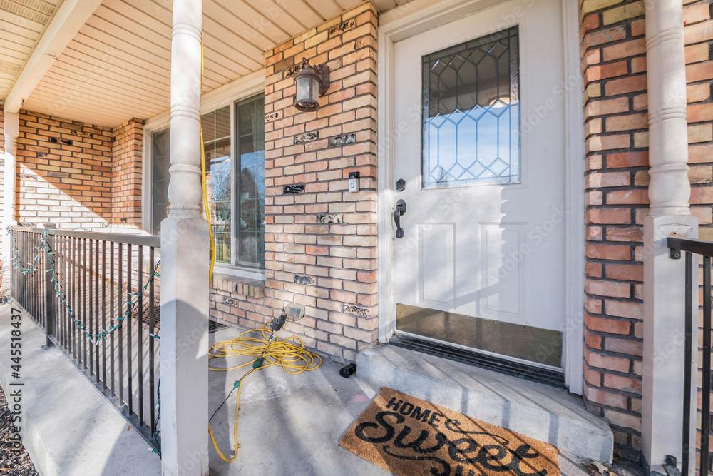 Front door with ornate glass panel and a home sweet home doormat Front door with ornate glass panel and a home sweet home doormat