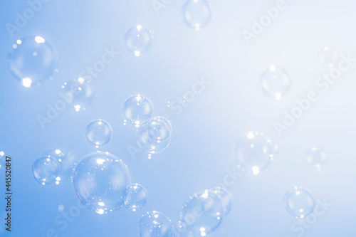 Beautiful Transparent Soap Bubbles Floating on Blue Background.