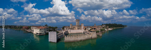 Aerial panorama of Sirmione castle, Lake Garda, Italy. Top view of the 13th century castle. Italian castles Scaligero on the water. Clouds over Sirmione, Lake Garda in Italy.