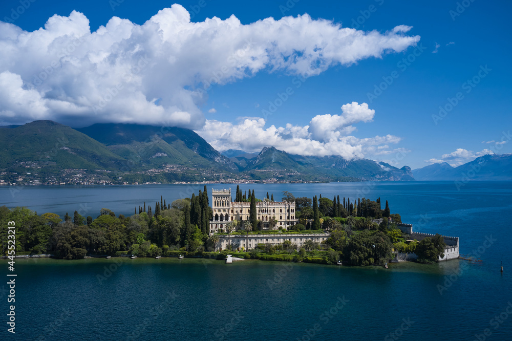 Isola del Garda, Italy. Magnificent aerial panorama of Isola del Garda, Lake Garda, Italy. An island surrounded by the Italian Alps. Castle on an island in Italy. Historic sites on Lake Garda.