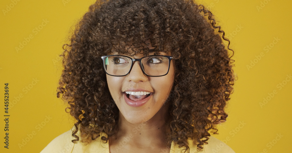 Young Latin woman with curly hair happy with her glasses. Eye care concept. Young Latin woman with curly hair happy with her glasses. Eye care concept.