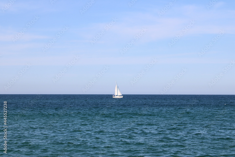 White sailboat cruising on the ocean White sailboat cruising on the ocean