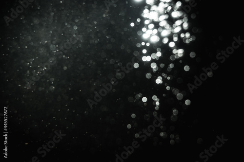 Glittering stars of blur white bokeh with black background