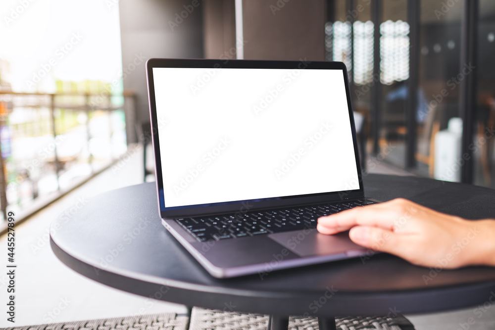 Mockup image of a woman using and touching on laptop touchpad with blank white desktop screen Mockup image of a woman using and touching on laptop touchpad with blank white desktop screen